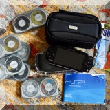 E03. PSP with movies, games and accessories. 